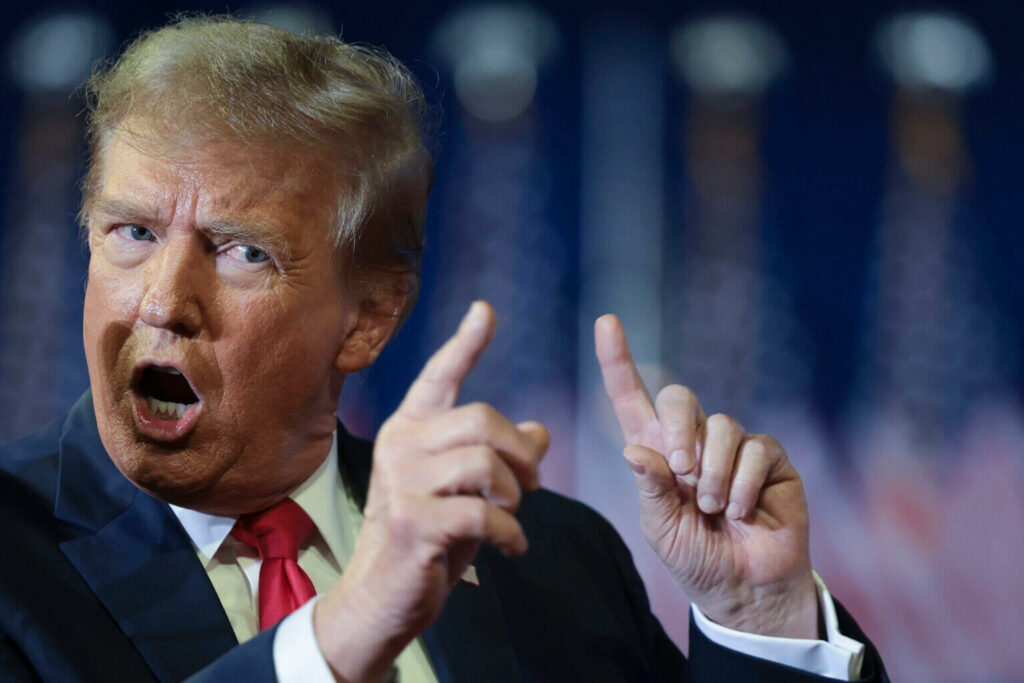 Photograph of Donald Trump showing his size with his fingers.